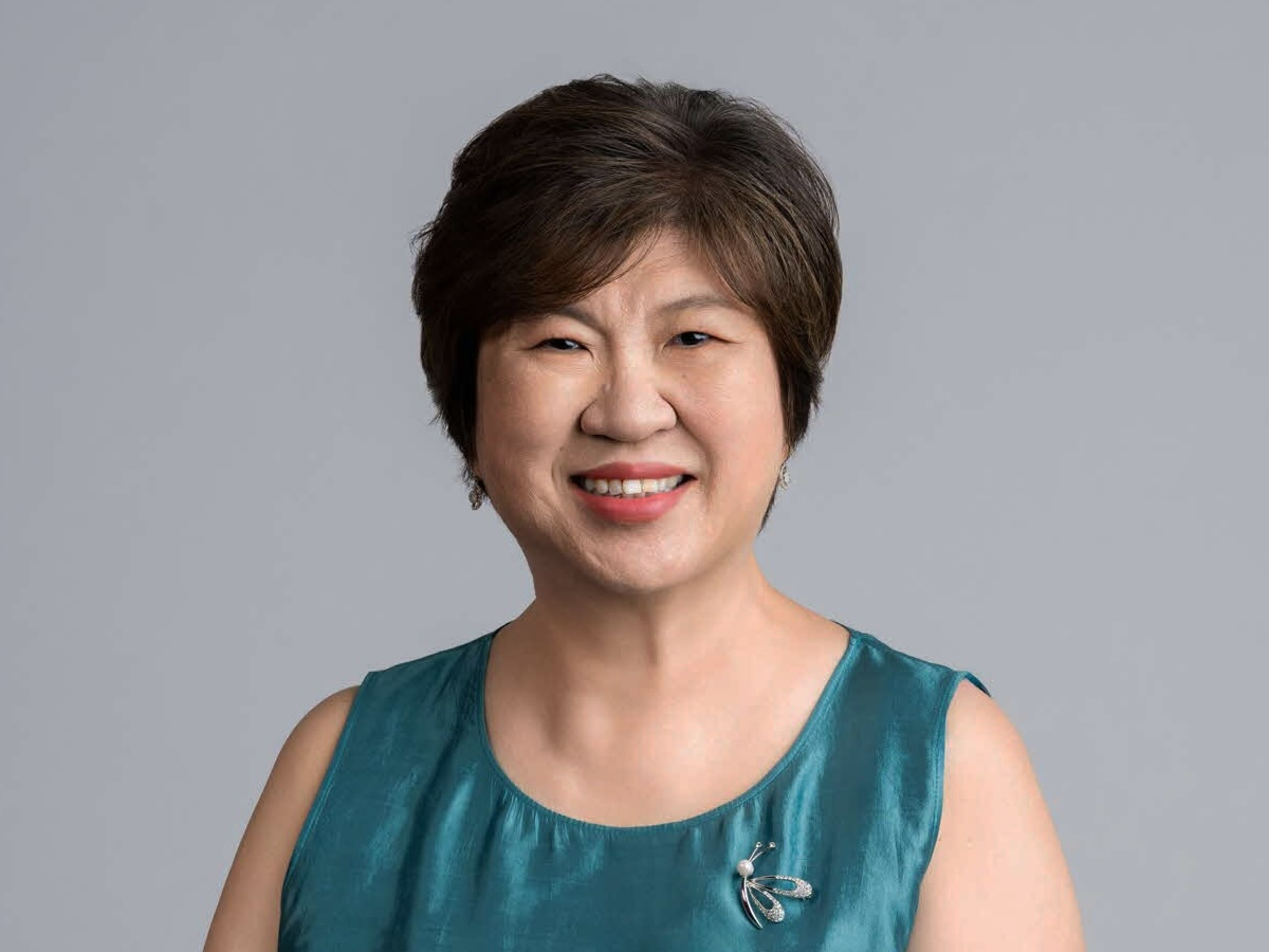 Ms Janet Ang in turqoise dress, smiling